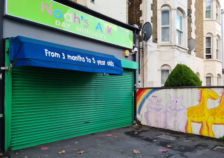 A closed green shutter beneath the green signage for a nursery called Noah's Ark