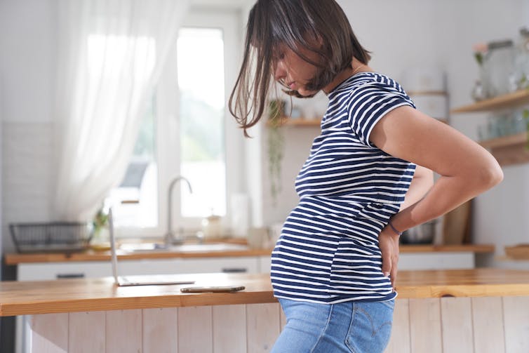 A pregnant woman experiences back pain