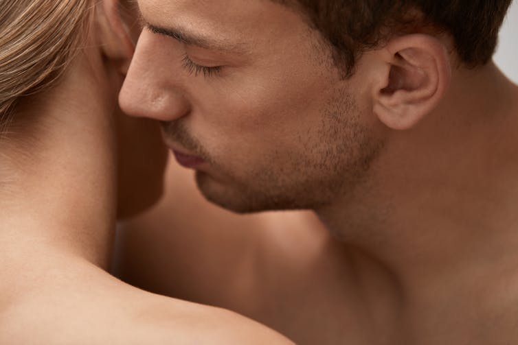 A man smelling his girlfriend's hair