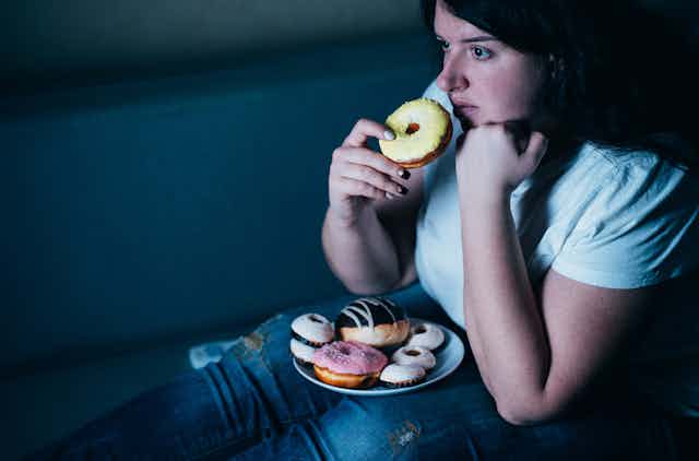 A woman eating doughnuts