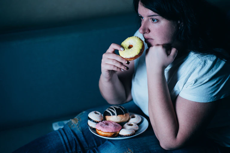 A woman eating doughnuts