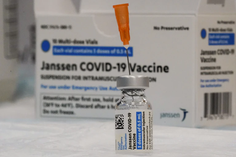 A vial of the Johnson & Johnson vaccine with a box in the background.