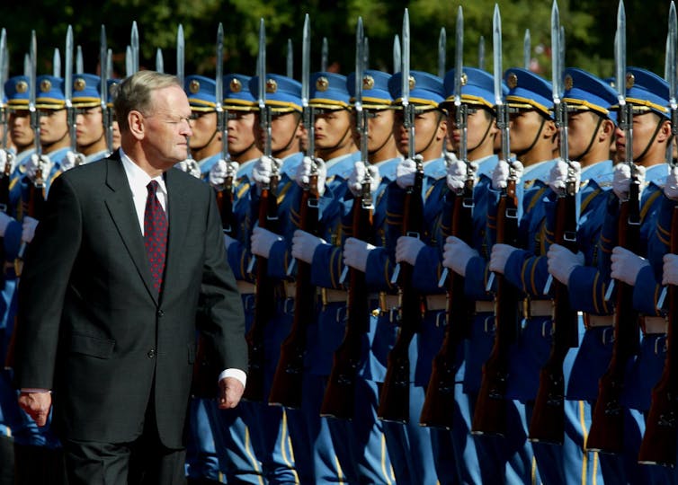 Chretien inspects the honour guard in Beijing.