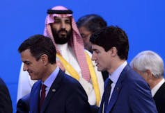 Crown Prince of Saudi Arabia Mohammed Bin Salman looks towards Justin Trudeau