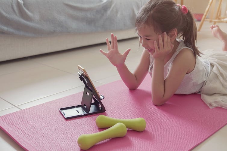 Young child talking to others on device.