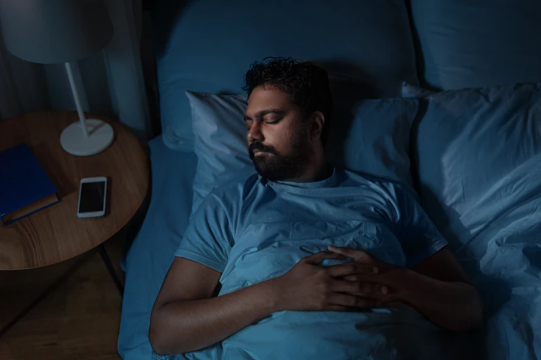 A man asleep in bed.