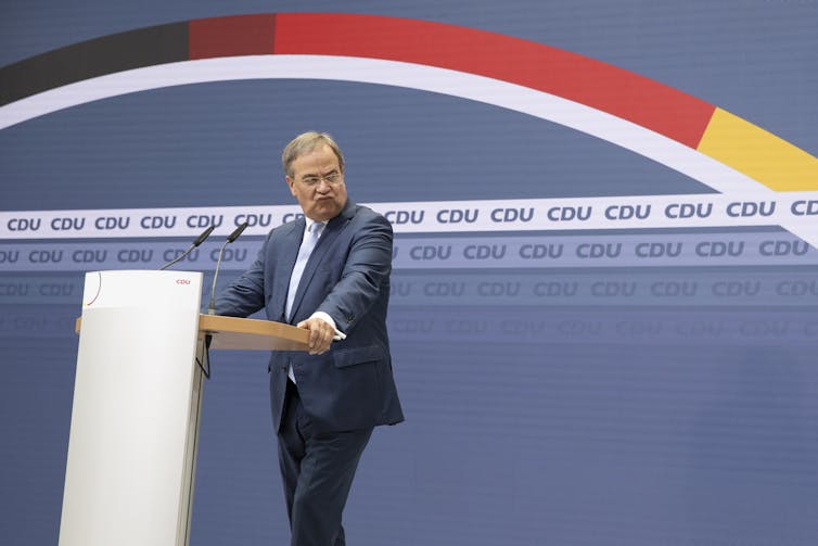 Armin Laschet pulling a disgruntled face during a press conference.