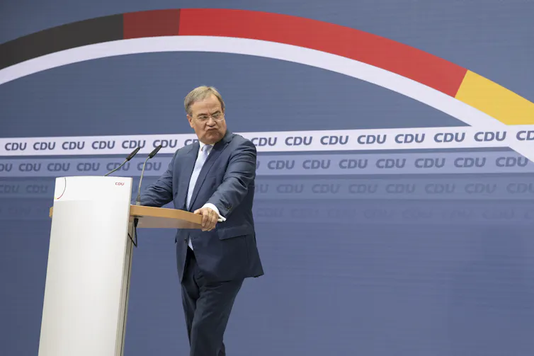 Armin Laschet pulling a disgruntled face during a press conference.
