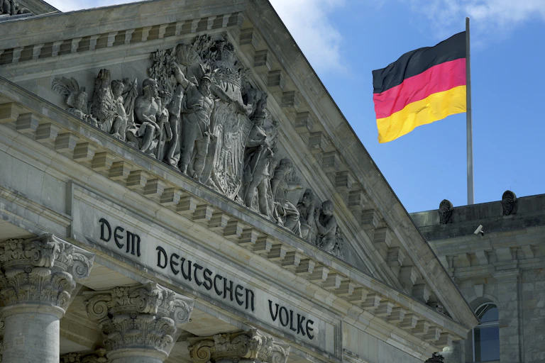 The German Reichstag with a German flag flying.