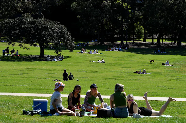People picnic in a park.