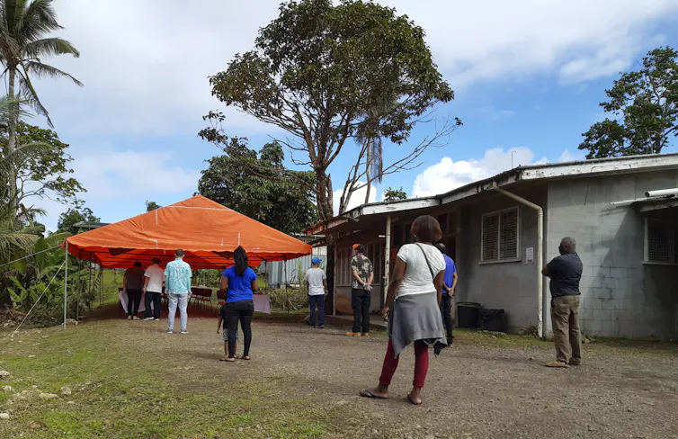 Fijian people waiting to be vaccinated