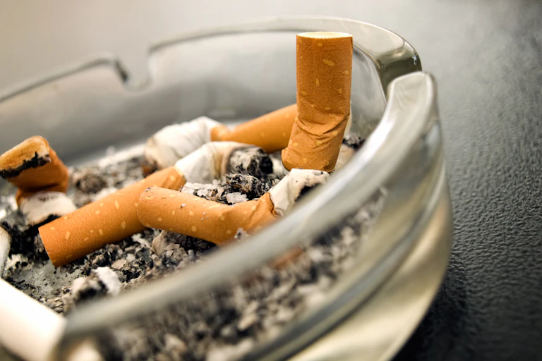 Ashtray with butted out cigarettes.
