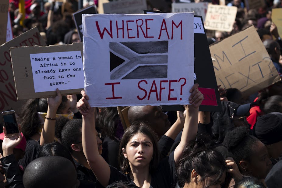 A woman carries a placard asking 'Where am I safe' during a march against gender-based violence in Cape Town, South Africa.