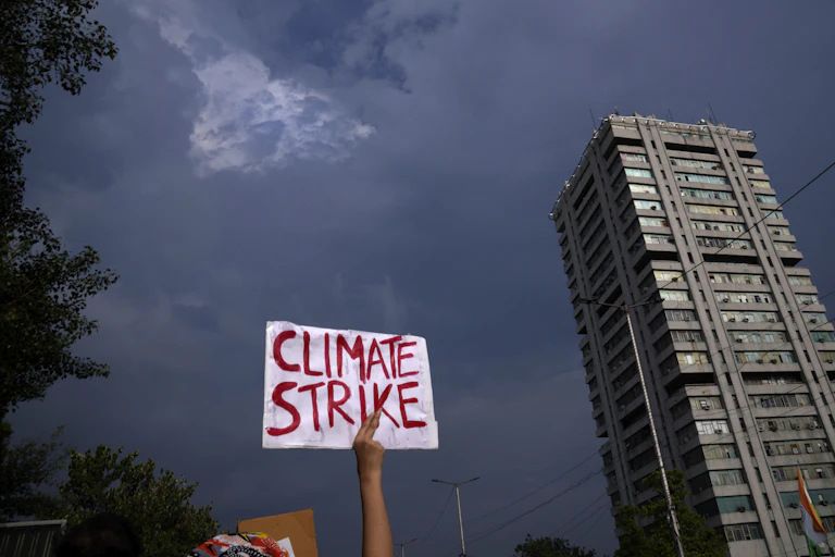 A sign reading climate strike held aloft