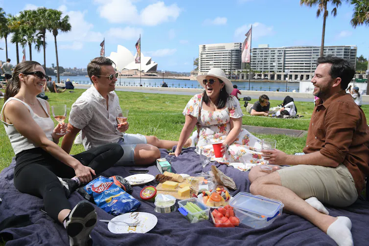 People picnic in the sun in Sydney.
