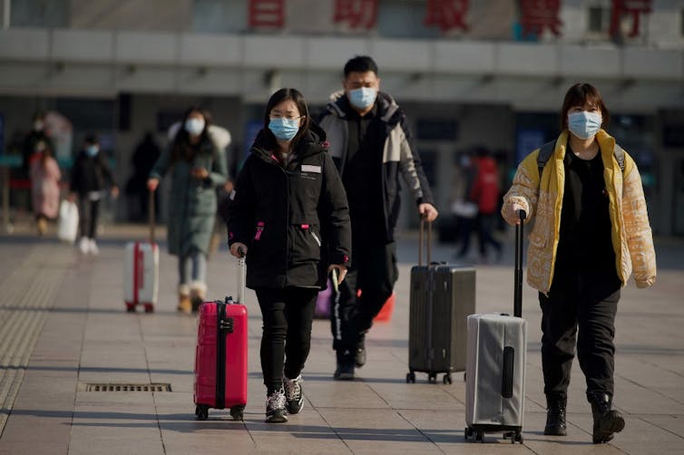 People arrive at Beijing railway station on February 8, 2021, ahead of the biggest holiday of the year, the Lunar New Year, which ushers in the Year of the Ox on February 12