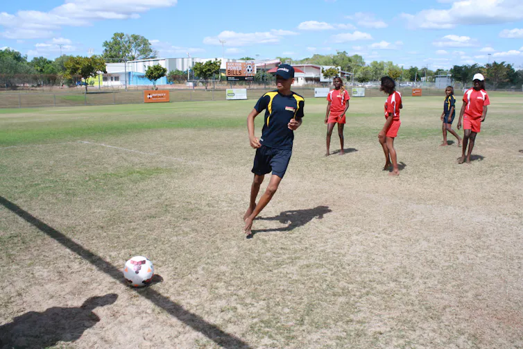 Aboriginal young people playing soccer in Darwin.