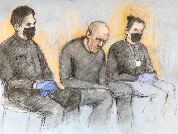 A court artist's drawing of Wayne Couzens flanked by two police officers.