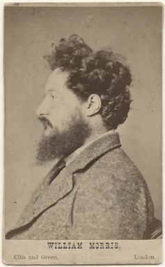 Black and white profile photo of William Morris with dark hair and beard.