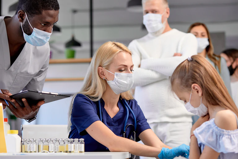 A teenage girl being vaccinated for COVID-19