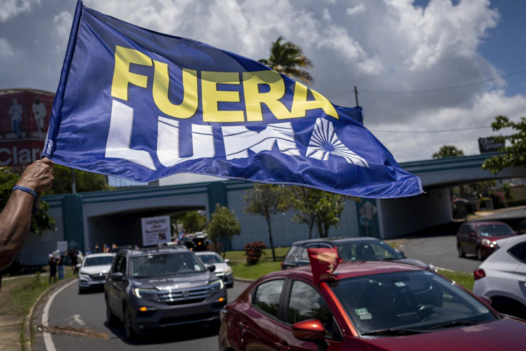 Flag waving over protesters driving past