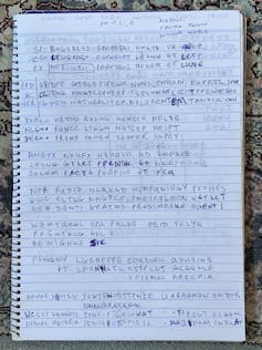 Latin and enciphered text written in notebook.