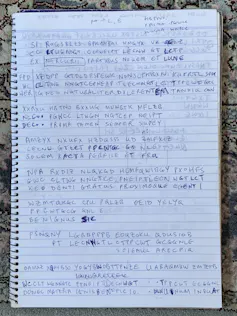 Latin and enciphered text written in notebook.