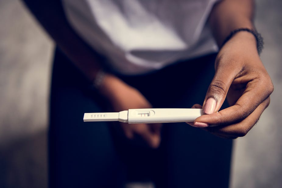 Closeup of woman with pregnancy test in a hand
