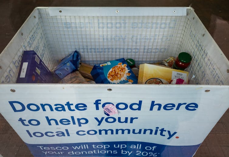 A food donation bin reading 'Donate food here to help your local community.'