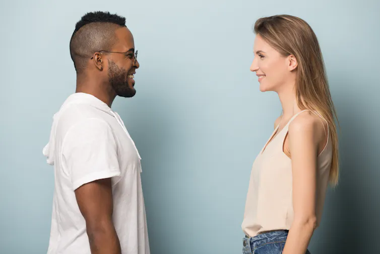 A man and woman facing one another