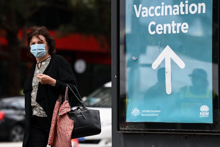 woman leaves vaccination centre