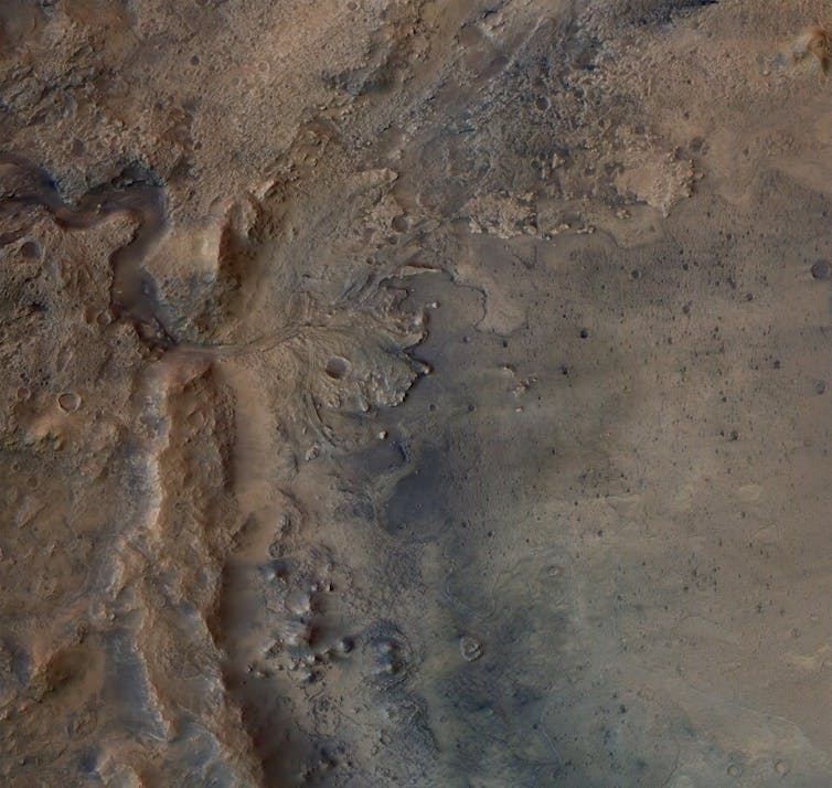 A satellite image showing a delta shaped rock formation on the surface of Mars.