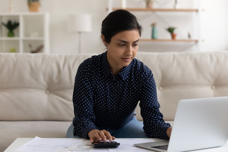 A woman looks at a screen