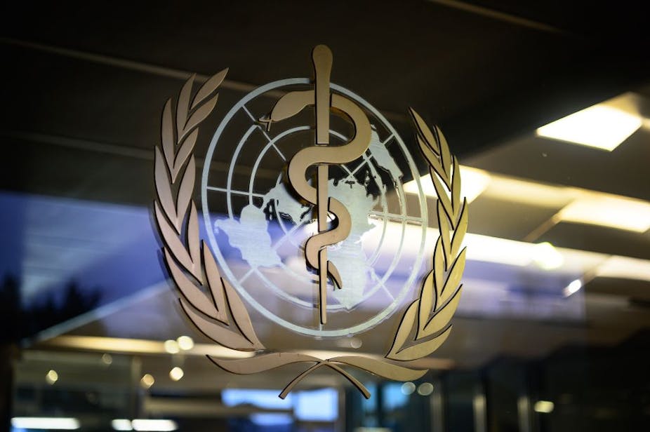 A World Health Organization (WHO) logo on a glass panel