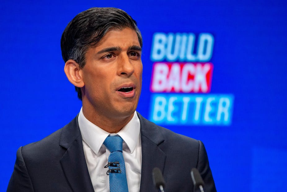 Chancellor of the exchequer, Rishi Sunak, speaks at the Conservative Party conference. A blue screen with the words 'Build Back Better' is behind him.