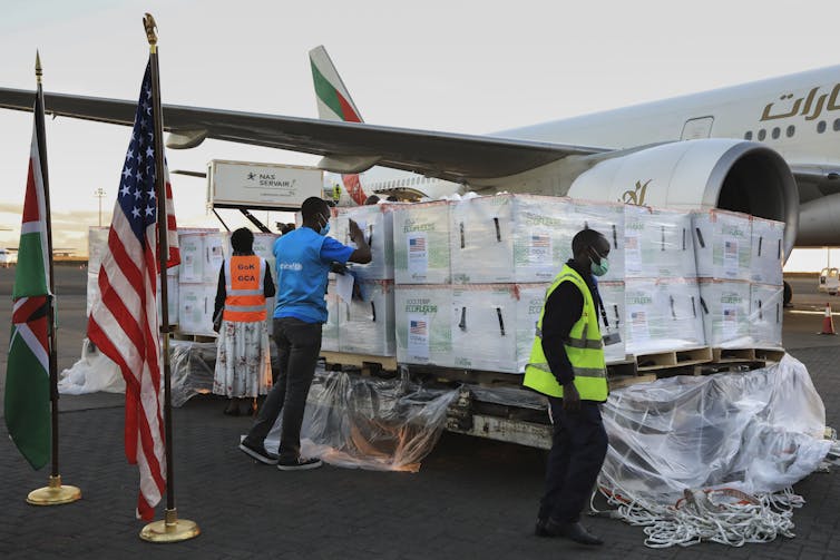 Vaccines donated through Covax being unloaded from a plane in Kenya