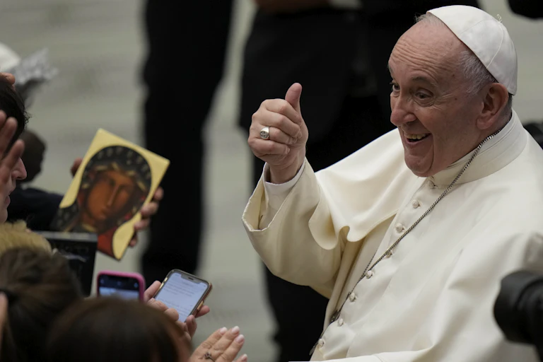 Pope Francis gives the thumbs up to listeners as he leaves his weekly general audience at the Vatican, on Sept. 22, 2021.