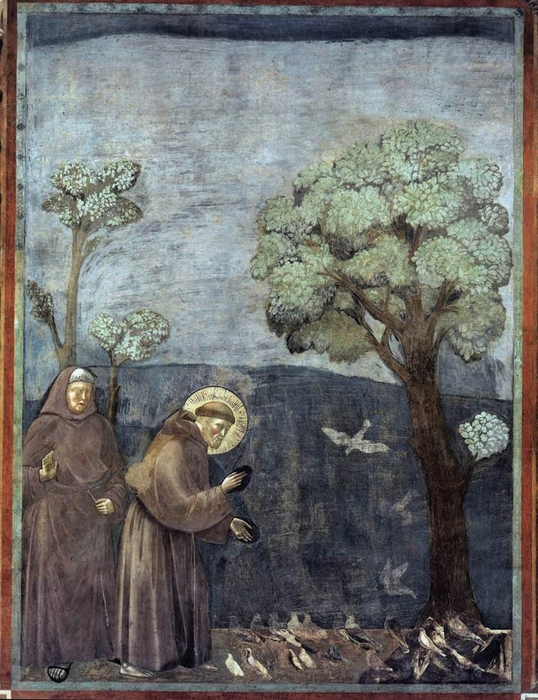 A fresco depicts St. Francis preaching to a group of birds under a tree, while another monk looks on.