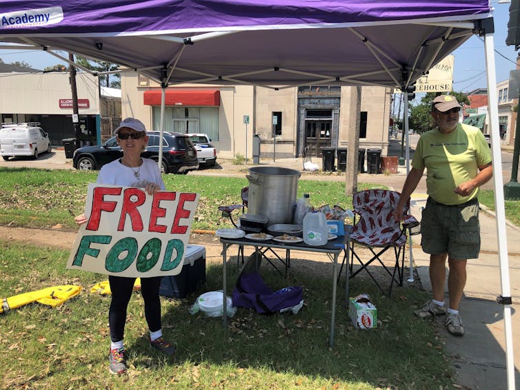 Joyce and Dave Thomas offer free jambalaya, cooked up by one of their neighbors in New Orleans after Hurricane Ida hit and left much of the city without power.