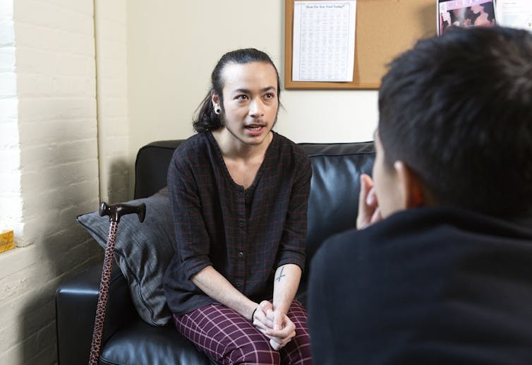 A genderqueer student talks with a health professional.