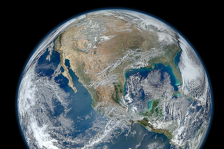 A satellite photo of Earth showing clouds over North America.