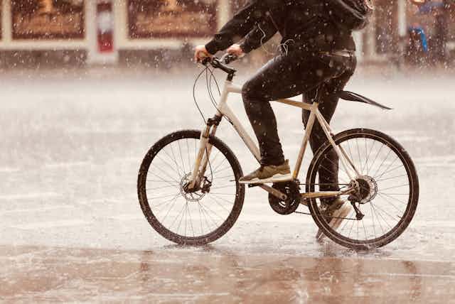 bottom half of cyclist in rain