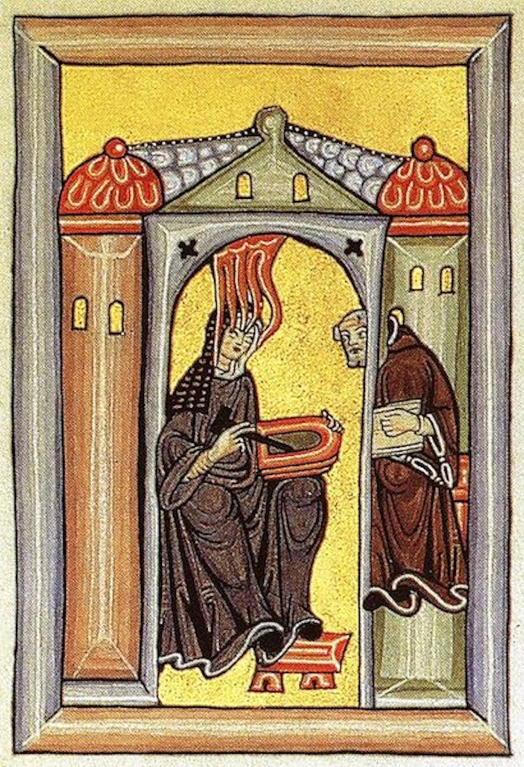 An illumination depicts Hildegard of Bingen experiencing a spiritual vision while dictating to a scribe.