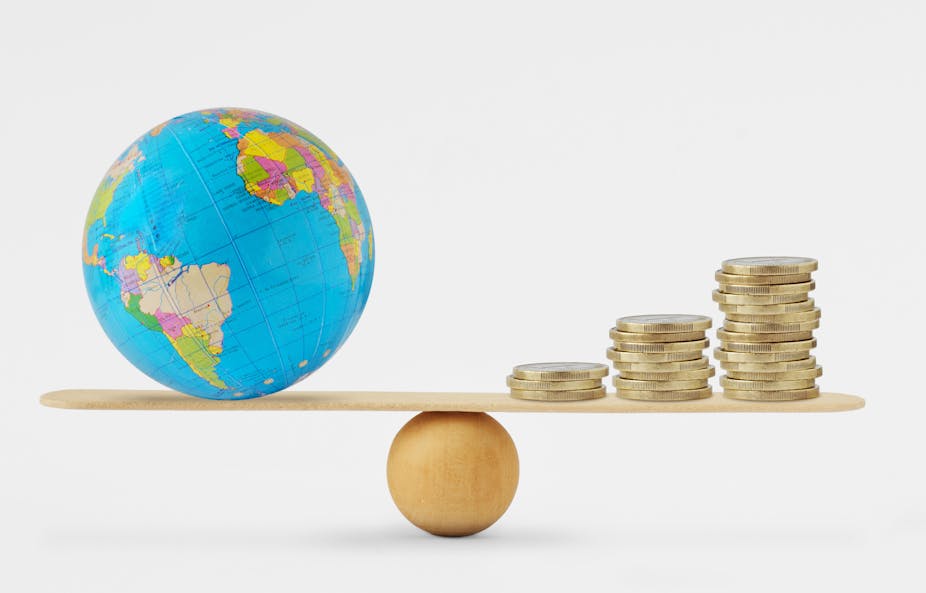 Illustration of a balance with the world on one side and money on the other.