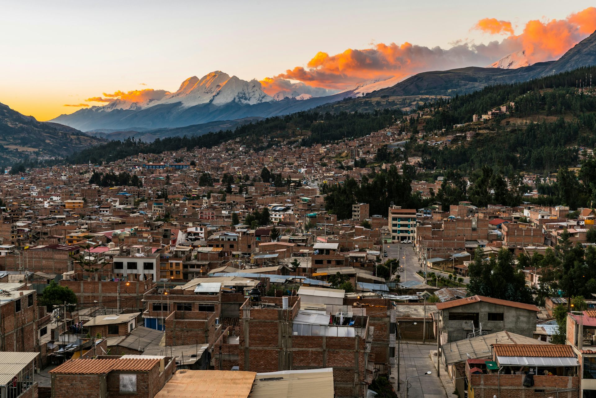 A panoramic view of Huaraz with a mountain range in the background.