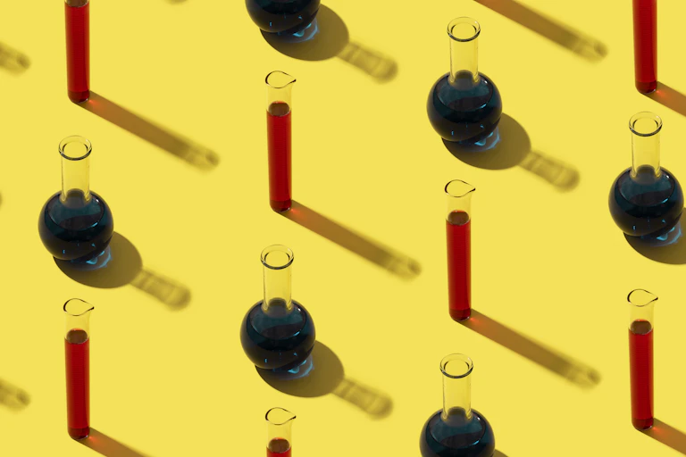 Test tubes and vials on a yellow background.