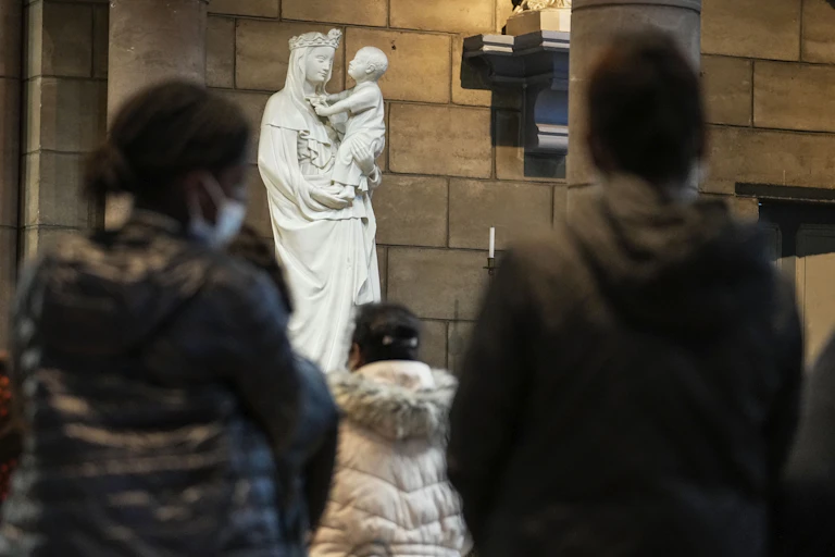 People pray for victims of sex abuse during a special service at the Catholic church Sainte Jeanne d'Arc de la Mutualité in Saint Denis, outside Paris, Oct. 5, 2021.