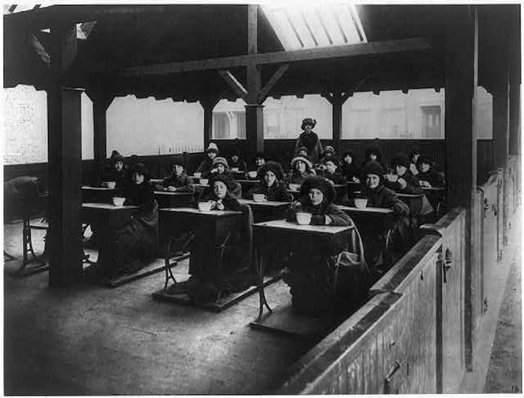 Black and white historical photograph. Kids in winter clothes.