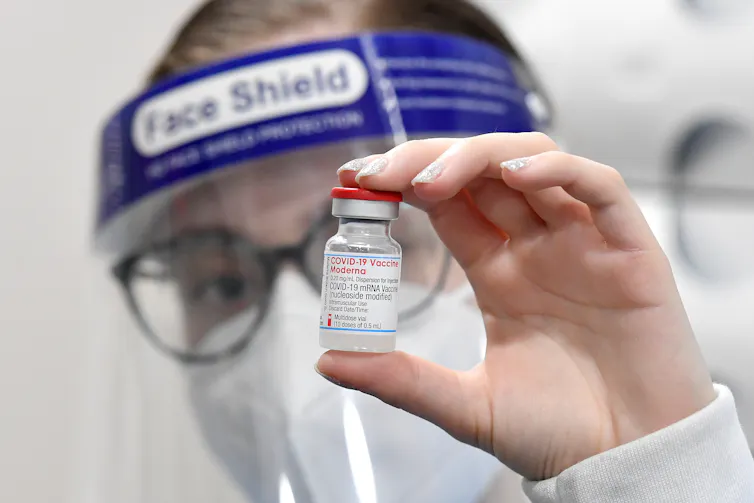 Health-care worker holding a vial of the Moderna COVID-19 vaccine