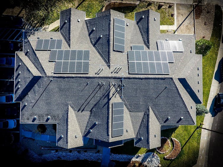 A bird's eye view of a roof with solar panels